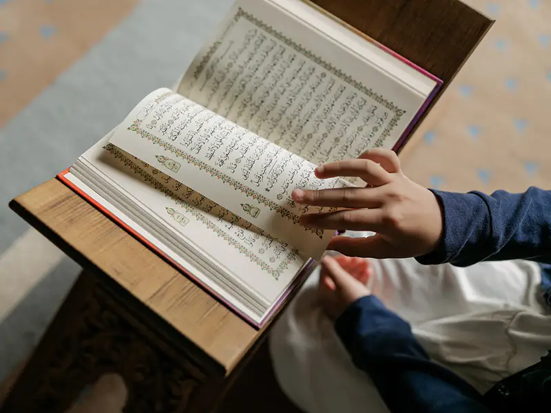 Boy reading Quran